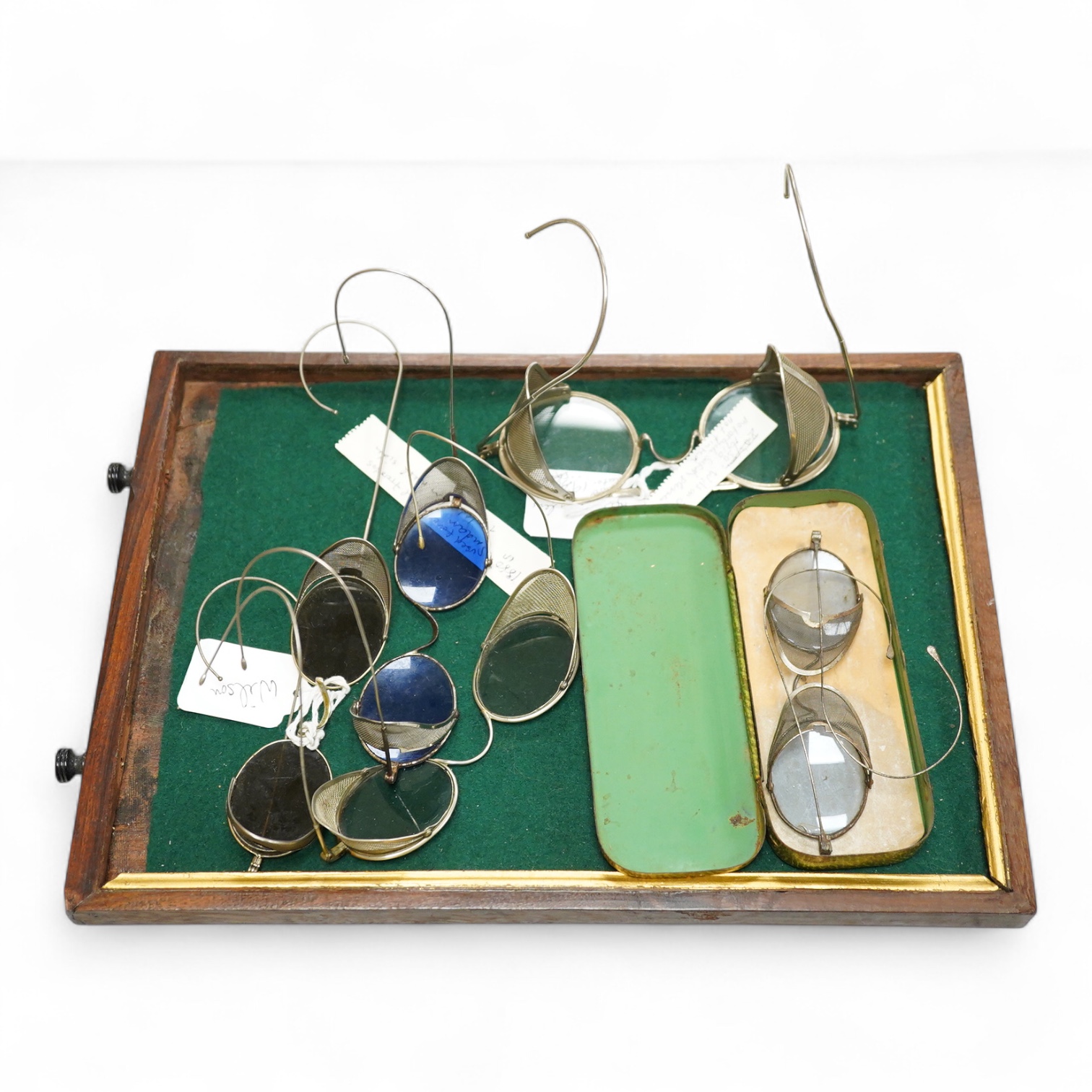 Two pairs of Willson, USA mesh sided safety glasses, and three similar pairs of unmarked glasses one in its original tin case marked BH (5)